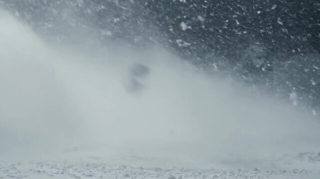 Dynamic snowfall event captured with swirling blizzard conditions and obscured visibility