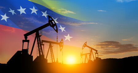 The change in oil prices. Oil price cap concept. Oil drilling derricks at desert oilfield with Venezuela flag. Crude oil production from the ground. Petroleum production.