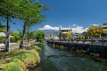 Fototapeta premium Fujinomiya town by river with mt. Fuji in springtime, Shizuoka