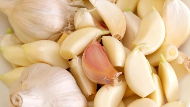 Fresh garlic cloves sliced whole peeled cooking ingredient close-up texture background