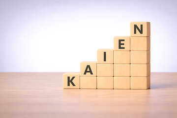 Kaizen continuous improvement concept with wooden cubes symbolizing progress and personal development approach
