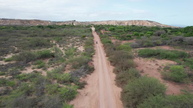 Aerial view of motorcycle riding on dirt road in Araya Peninsula