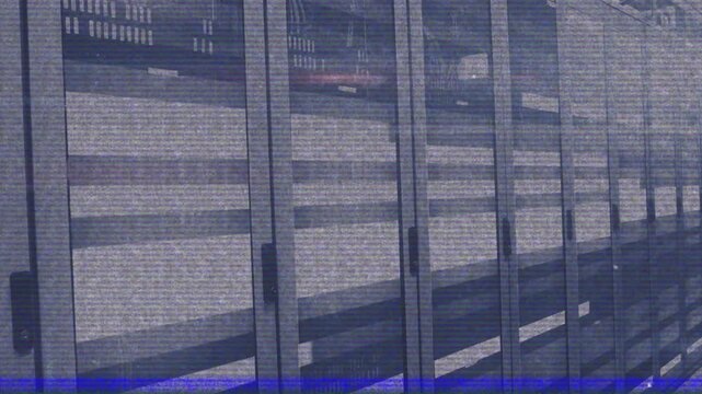 Playback starting camera panning laterally along server rack bank for corridor reveal