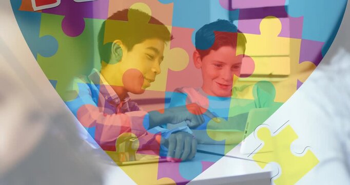 Animation of colourful puzzle pieces and autism text over kids friends using electronic devices