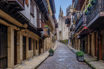 Fototapeta premium Main Street Of Hondarribia With Santa Maria Del Manzano Church, Spain, Traditional Houses