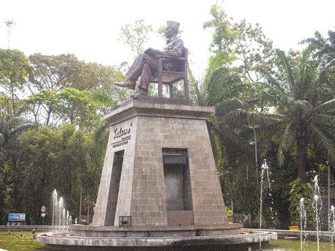 Solo Indonesia, July 3, 2025. Textured Art of Sukarno Statue Monument with Fountain Spray in Tropical Park