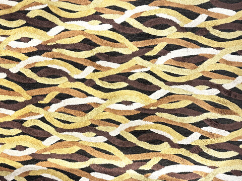 Close up of carpet rug in random wavy and curvy texture, in yellow, brown, and black color. Seamless background texture.