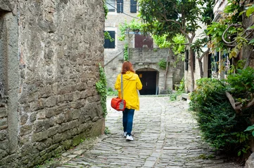 A woman walks down a small, cobbled street in a beautiful, small town on the Istrian peninsula © Vesna