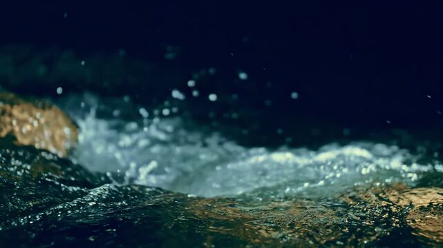 Slow motion ripple waves on dark water river.Super slow motion detail 4k video.Amazing dramatic night cinematic backgrounds.Epic mystical magic night view.Crystal clear spring river.Underwater stones