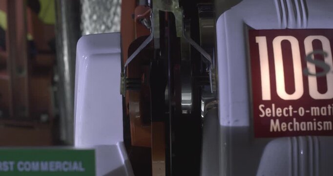 Close-up of a vintage jukebox playing a vinyl record on the turntable, retro 1950s style.
