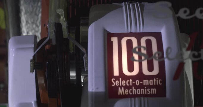 Close-up of a vintage jukebox playing a vinyl record on the turntable, retro 1950s style.