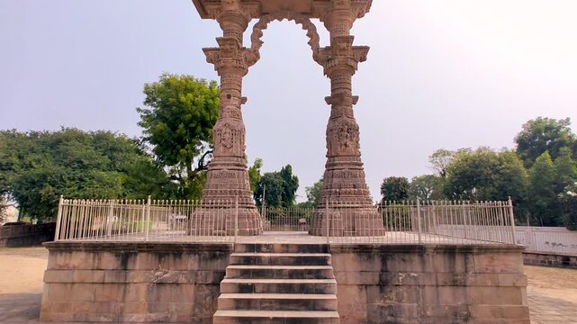 Narsinh Maheta Ni Chowri Vadnagar Gujarat India historic stone arch with detailed carvings, cultural heritage monument, traditional architecture, peaceful outdoor setting.
