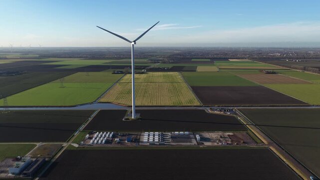 Aerial drone view of a large battery energy storage system next to a high voltage station at Wind Park Dronten, supporting renewable energy integration and reducing grid congestion.