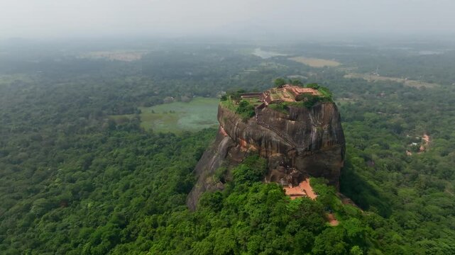 Sri Lanka drone footage over Sigiriya terraces and pools, highlighting the engineered water system and layered fortification walls.