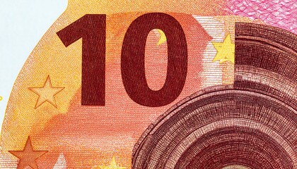 Macro detail of currency, showing a large value numeral and ornate printed security elements