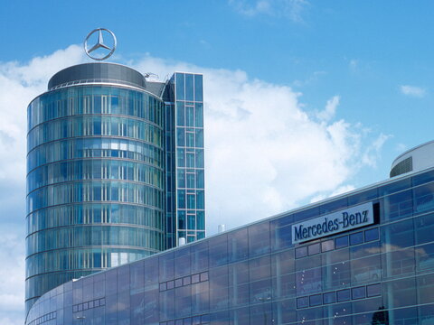 Iconic Mercedes-Benz strar on top of the modern glass tower and dealership and show room building in Arnulfstrasse Munich, Bavaria Germany Europe