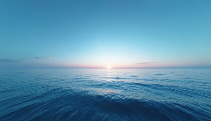 Obraz premium Vast ocean expanse under clear sky at sunrise. Gentle waves ripple on water surface, horizon glows with soft sun light. Peaceful sea landscape, nature beauty unfolds.