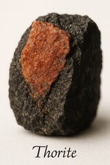 Natural thorite crystal ore on white background for mineralogy study