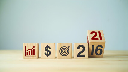 Strategic business plan development for financial growth and goal achievement in 2021, illustrated with wooden blocks displaying key performance indicators