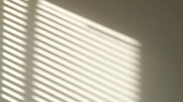 Shadows cast by blinds on a wall light and shadow play on a textured surface