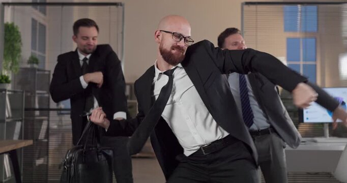 Businessmen dance in office celebrating success. Colleagues form a cheerful team, boosting morale and teamwork in a modern workspace. Concept captures fun corporate celebration energy.