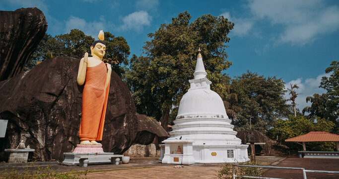 Buddha statue and white stupa at Yatagala Rajamaha Viharaya in Sri Lanka