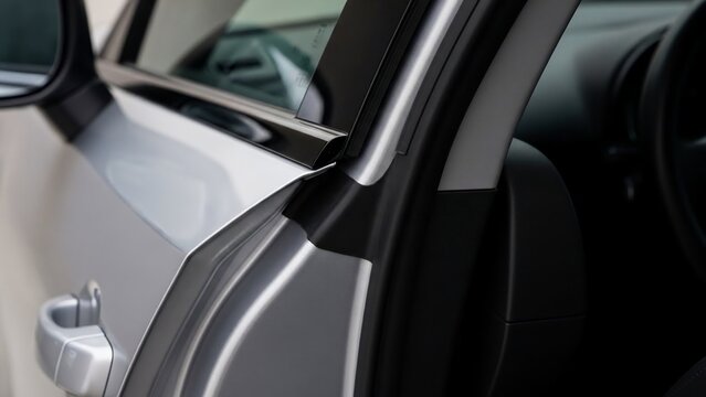 Modern car interior with sleek door and dashboard design.
