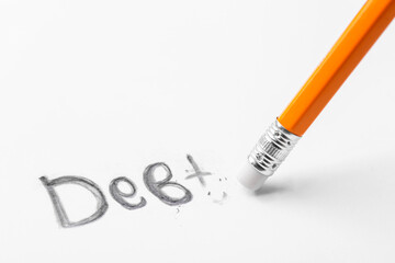 Erasing word Debt written on white background, closeup