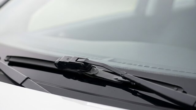 Car windshield wiper blades on a white vehicle.