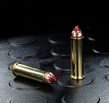 Two 357 magnum cartridges on a rubber work mat