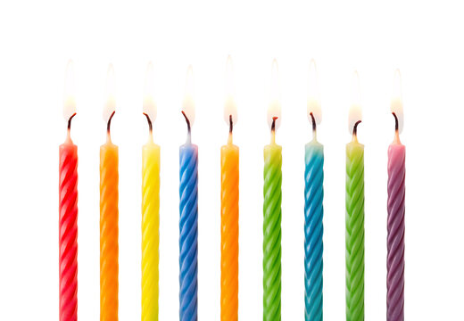 Nine colorful spiral birthday candles lit, isolated on a transparent background