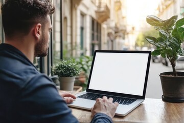 Man working using laptop with blank white screen mockup.