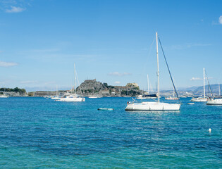 Stunning view of the ionian sea with some sailing boats and the wonderful old town of corfu