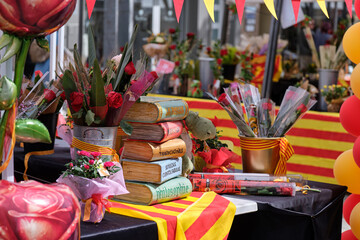 Books and red roses displayed at a vibrant street market stall celebrating Sant Jordi in Catalonia © Jordi