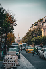 Busy Istanbul street with traffic and historic mosque in background