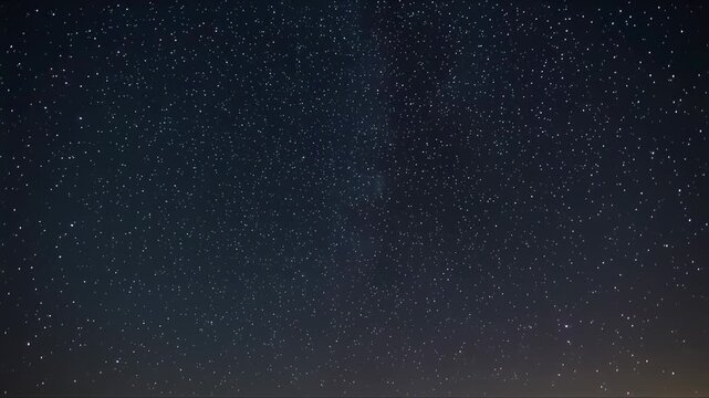 Night sky with stars and aurora borealis viewed from a serene landscape at dusk video