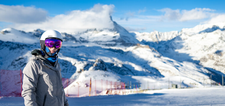 Female Skier smiling in Zermatt Mountains with Matterhorn Peak Background