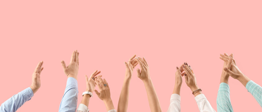 Many hands clapping on pink background