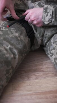 A combat medical tourniquet stops blood flow during first aid.