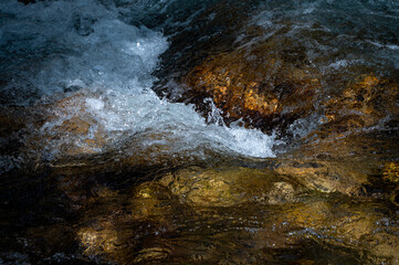 Close-up of water droplets flowing in a stream