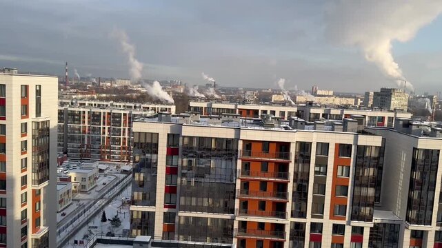 Winter season, winter city view in frosty sunny clear weather, new buildings, modern houses, snowy city landscape, view from above, horizontal video