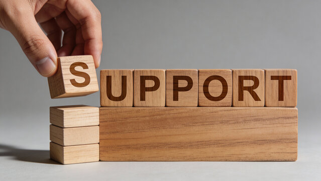 Hand Placing "S" Cube to Form the Word SUPPORT