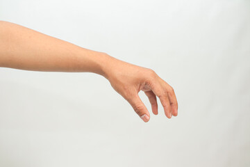 Human arm reaching down with fingertips extended against a plain white background