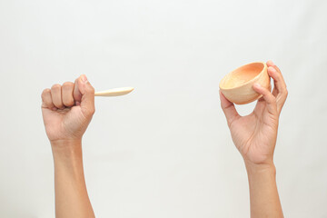 Person Holding Wooden Spoon and Bowl Isolated on White Background