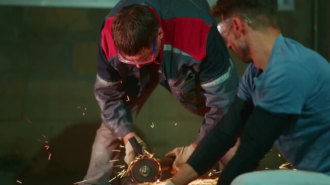 white men cutting metal with grinder in workshop, mentor guiding apprentice through precise angle cutting, sparks flying, protective gloves and goggles, focused teamwork