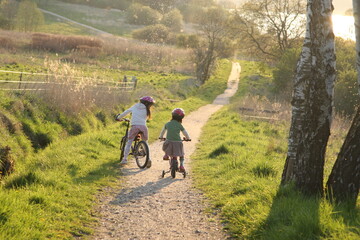 Naklejka premium 2 Children in bikes on a path in nature in Denmark