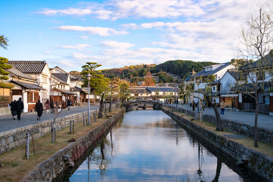 Canals of Kurashiki Bikan Historical Quarter with white traditional houses in Okayama, Japan in winter before sunset