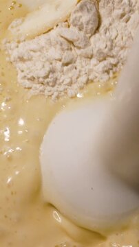The blender whips the batter for pancakes, pancakes. Cooking dough in the kitchen
