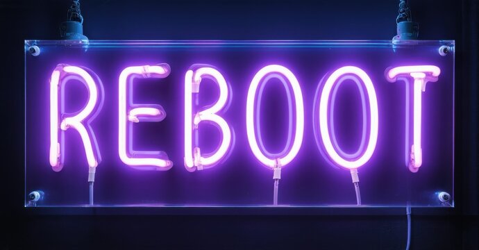 Bright purple neon sign spells REBOOT. Dark background emphasizes glowing text. Simple design, modern aesthetic. Minimalist presentation.
