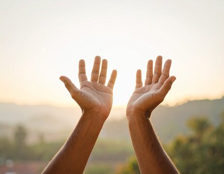 Raised Hands in Prayer Gesture on Mountain Nature Background for Somatic Healing and Mindfulness